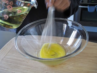 Whisking egg yolks in a bowl.