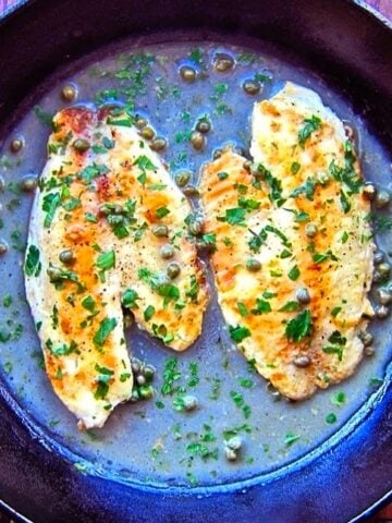 Tilapia piccata in a cast iron skillet