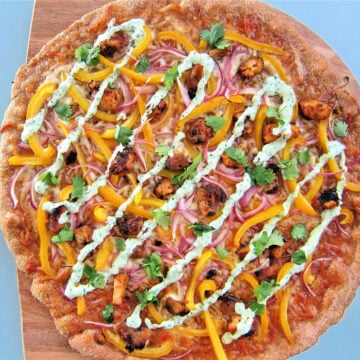 Tandoori chicken pizza on pizza peel