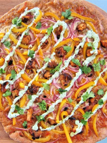 Tandoori chicken pizza on pizza peel
