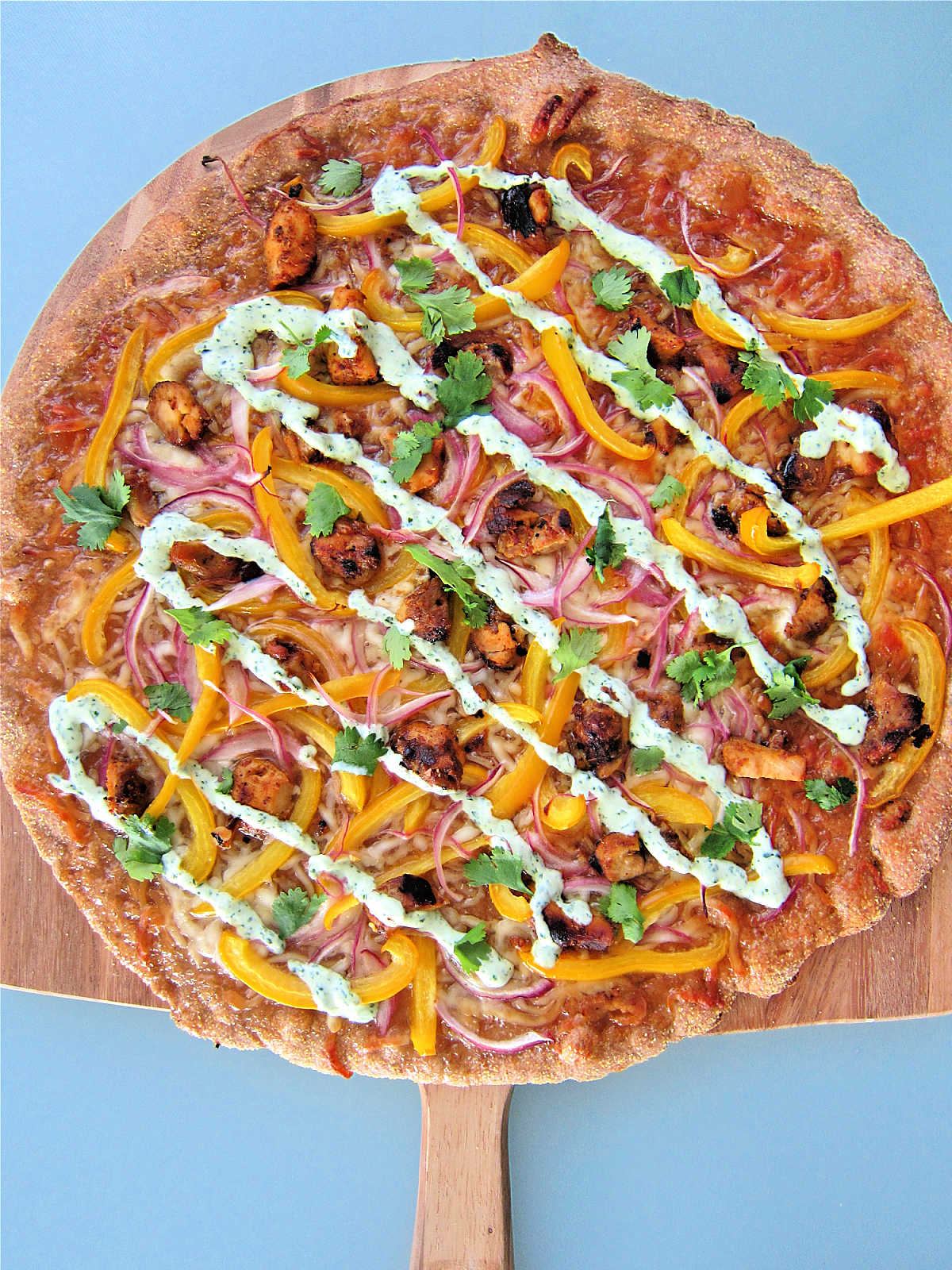 Tandoori chicken pizza on pizza peel