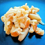 Pile of roasted garlic on a black plate