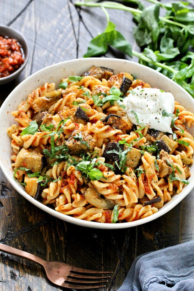 red pesto pasta in a bowl angled shot