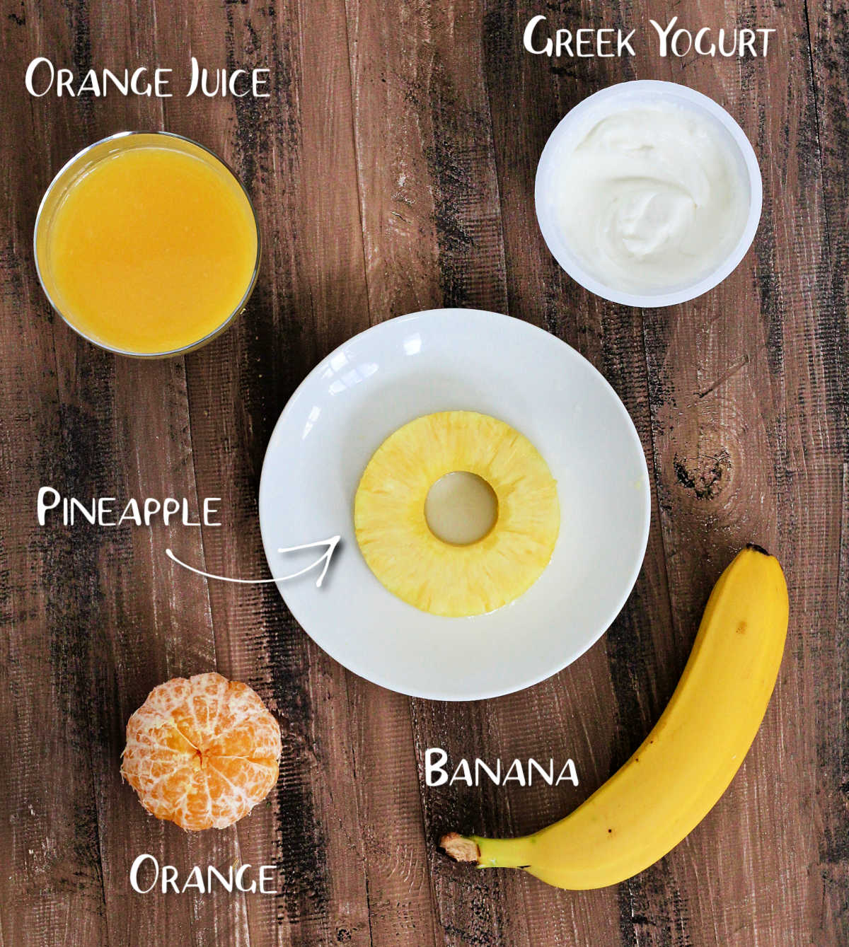 Ingredients for pineapple banana smoothie on a wooden board.
