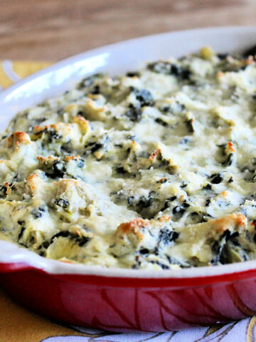Healthy spinach artichoke dip in red casserole dish