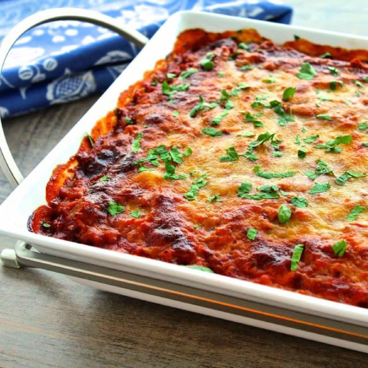 Spaghetti squash lasagna casserole in white baking dish.