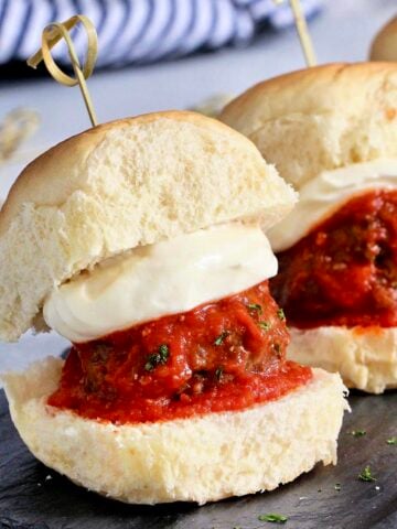 Row of meatball sliders with whipped ricotta