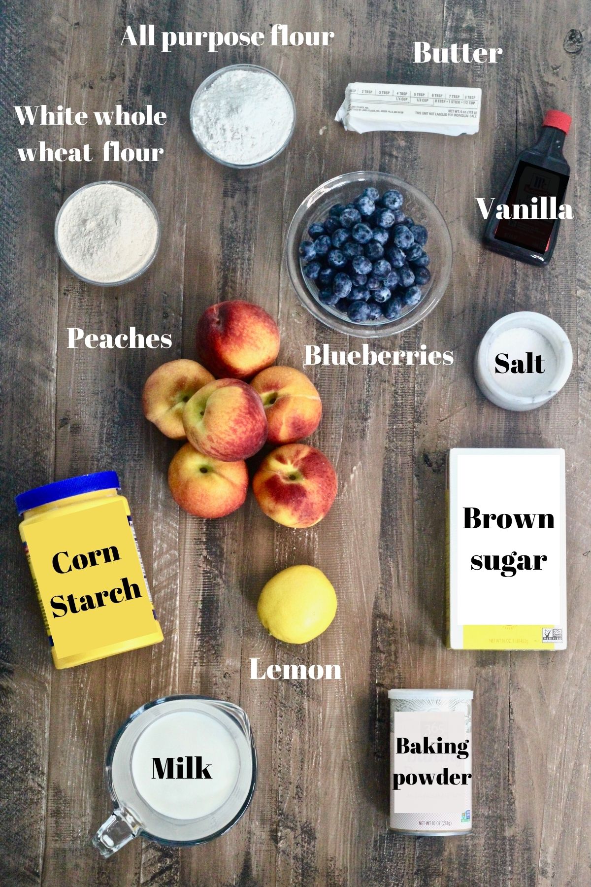 Inngredients for blueberry peach cobbler on a wooden board.