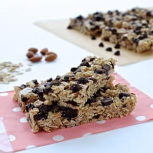 Two granola chocolate cherry granola bars on a pink polka dot paper bag