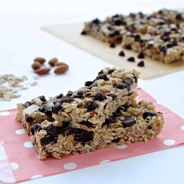 Two granola chocolate cherry granola bars on a pink polka dot paper bag