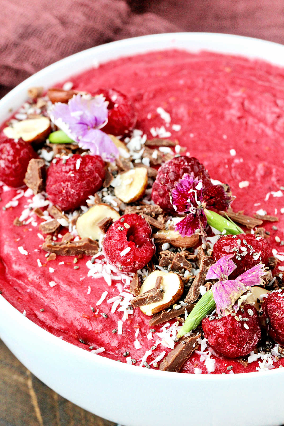 Close up of Raspberry Coconut Smoothie Bowl in white bowl.
