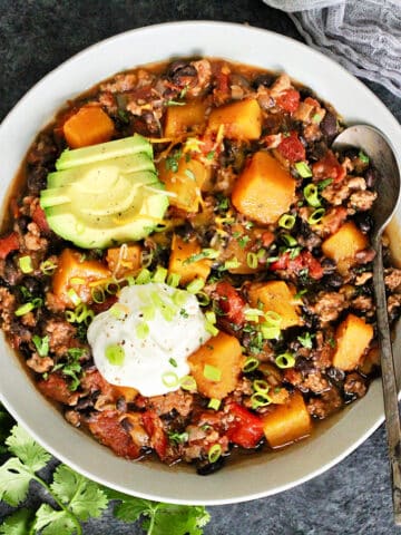 Overhead photo of Butternut Squash & Turkey Chili in a white bowl.