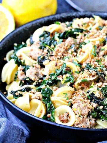 Orecchiette with Kale, Turkey Sausage and Gremolata Breadcrumbs in a black bowl.