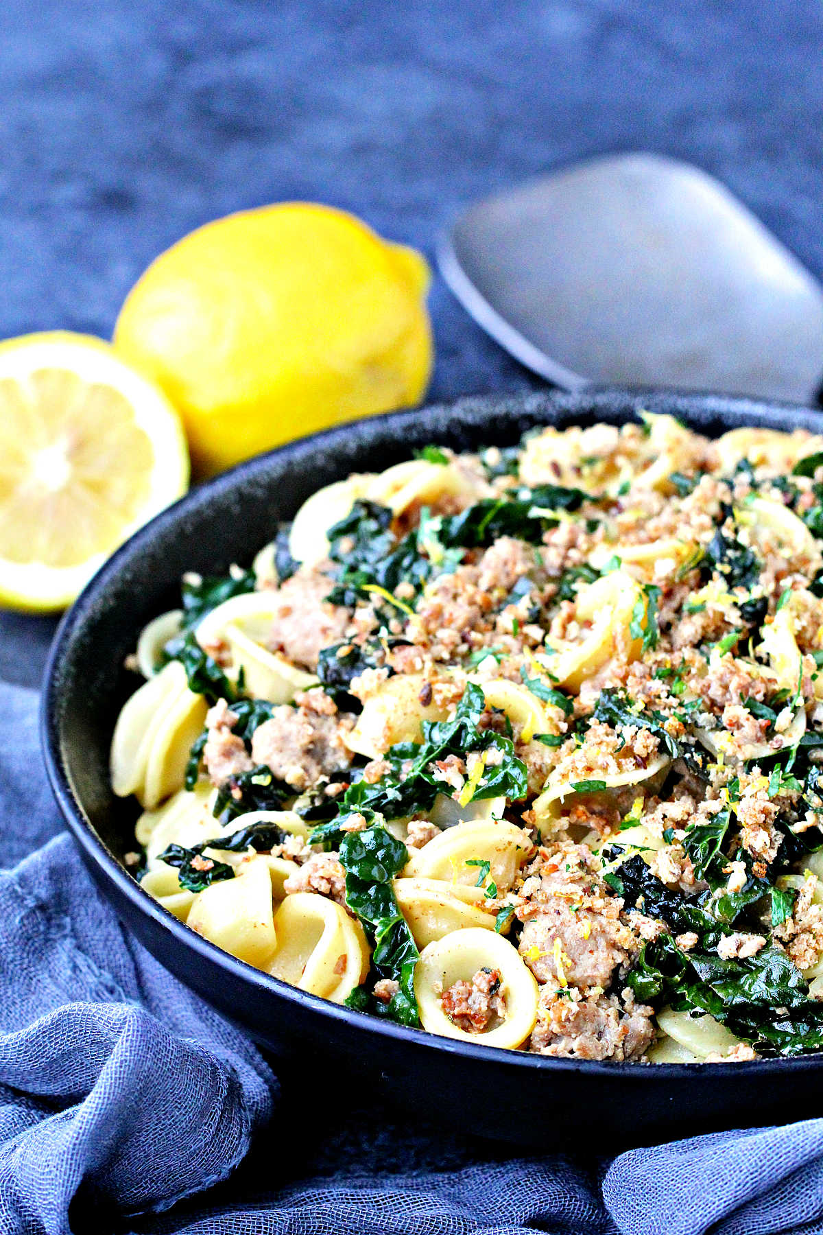 Orecchiette with Kale, Turkey Sausage and Gremolata Breadcrumbs in a black bowl.