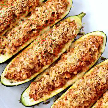 zucchini boats in a white baking tray.