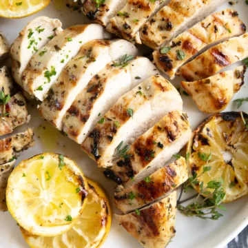 sliced chicken on a white platter