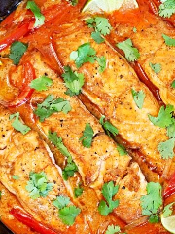 Thai salmon curry in a cast iron skillet