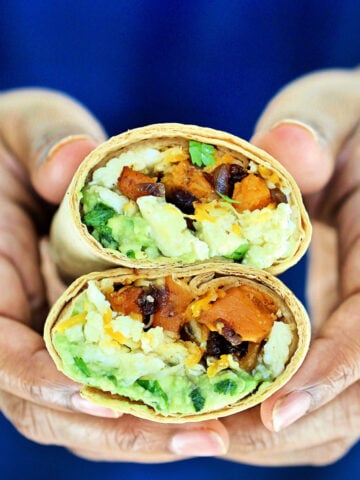 holding burrito cut in half