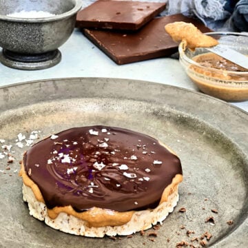 Giant peanut butter cup rice cake on a silver plate.