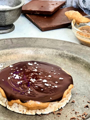 Giant peanut butter cup rice cake on a silver plate.