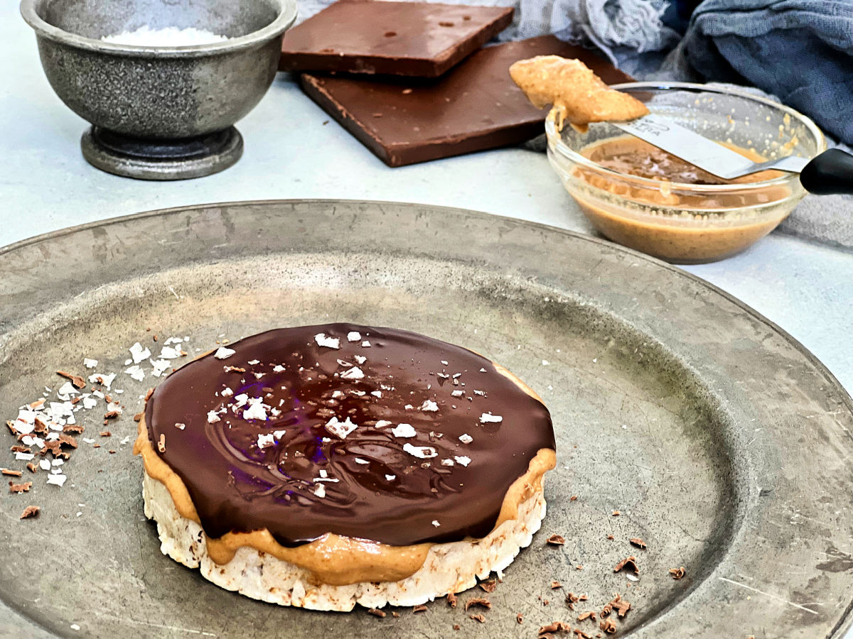 Giant peanut butter cup rice cake on a silver plate.