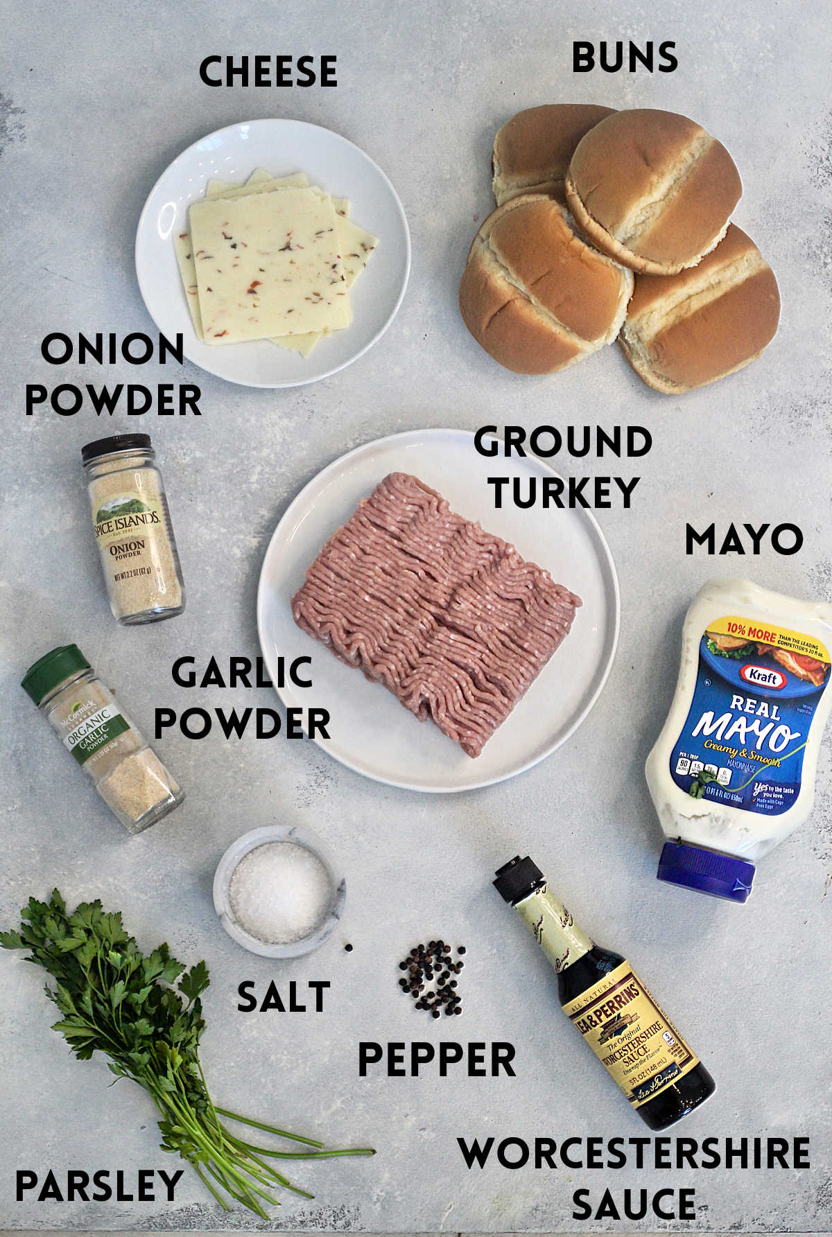Ingredients for air fryer turkey burgers on a light gray board.