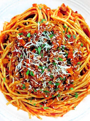 spaghetti bolognese in a white bowl.