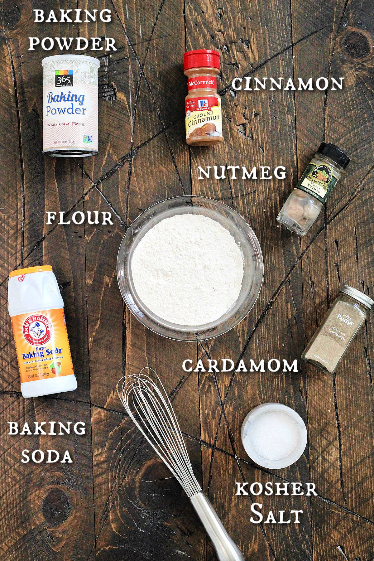 Dry ingredients for baked apple cider donuts on a brown wooden board. 