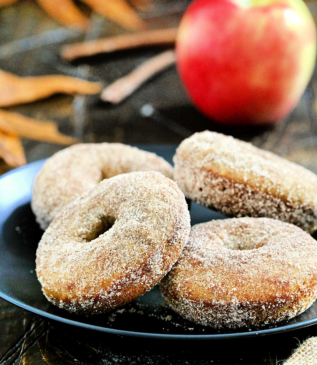 Baked apple cider donuts on a plate.