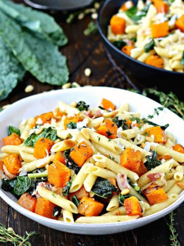 Roasted Butternut Squash Pasta with Kale in white bowl.