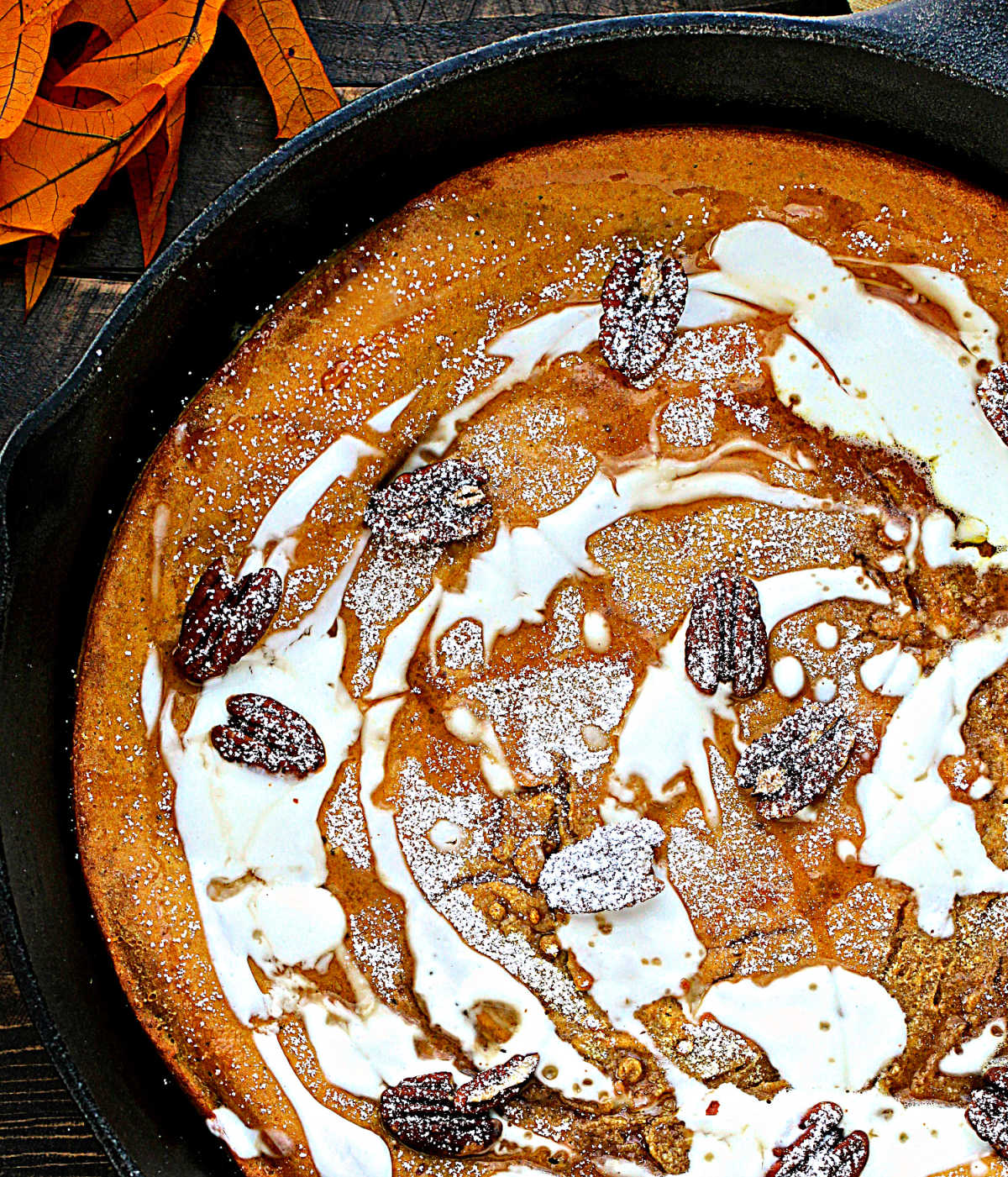 Close up overhead of Pumpkin Spice Dutch Baby in cast iron skillet.