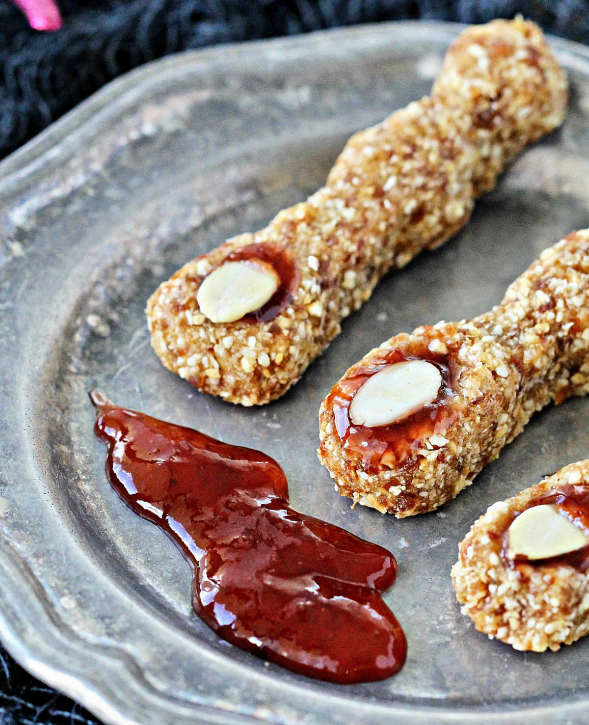 Spooky Witches’ Fingers on a silver plate with strawberry preserves.