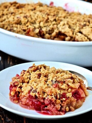 Piece of Apple cranberry crisp on a white dish