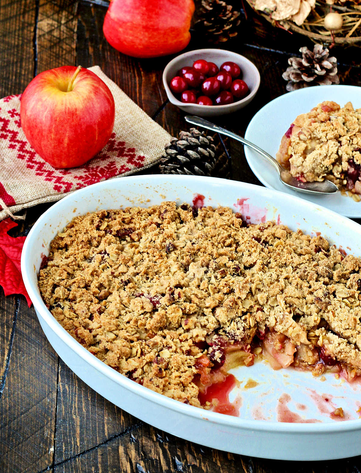 Apple cranberry crisp in white serving dish
