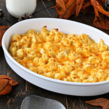 Cauliflower mac and cheese in a white baking dish.