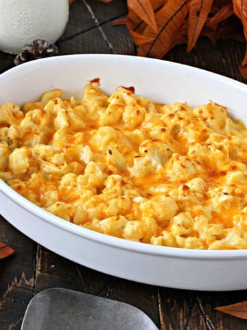 Cauliflower mac and cheese in a white baking dish.