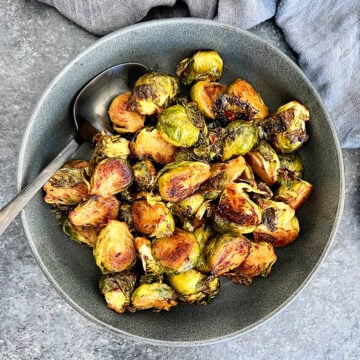 Miso roasted Brussels sprouts in a gray bowl.