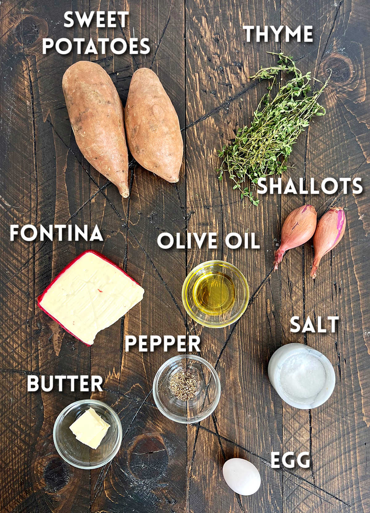 Ingredients for Twice-baked sweet potatoes on a wooden board.
