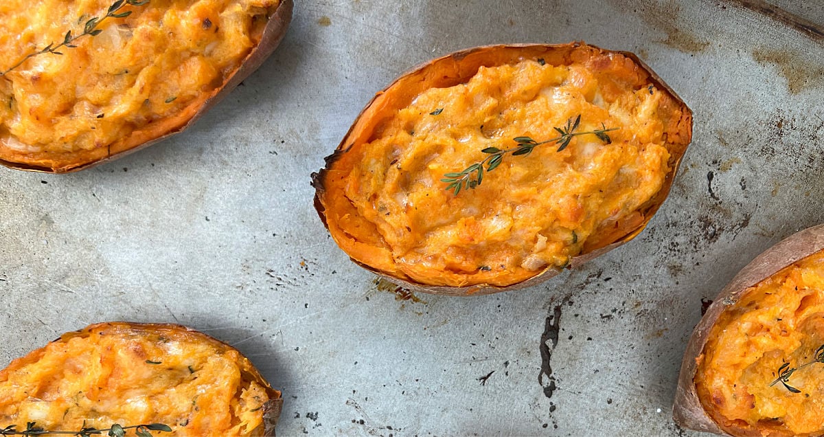 Twice-baked sweet potatoes on a sheet pan.