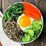 Korean ground turkey rice bowl with meat, veggies, and a fried egg.