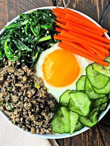 Korean ground turkey rice bowl with meat, veggies, and a fried egg.
