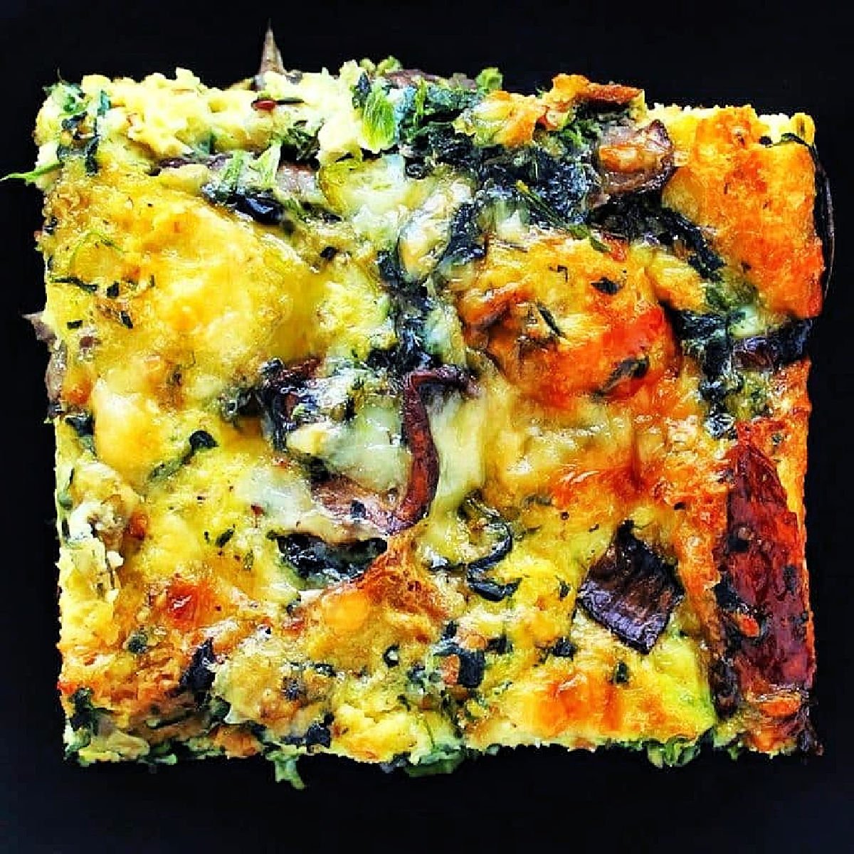 Spinach, Mushroom and Gruyere Strata on black plate