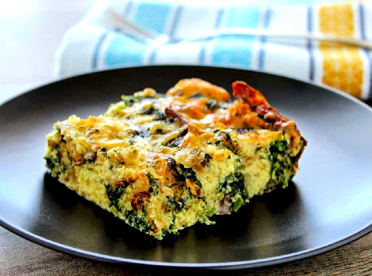 Spinach, Mushroom and Gruyere Strata on black plate