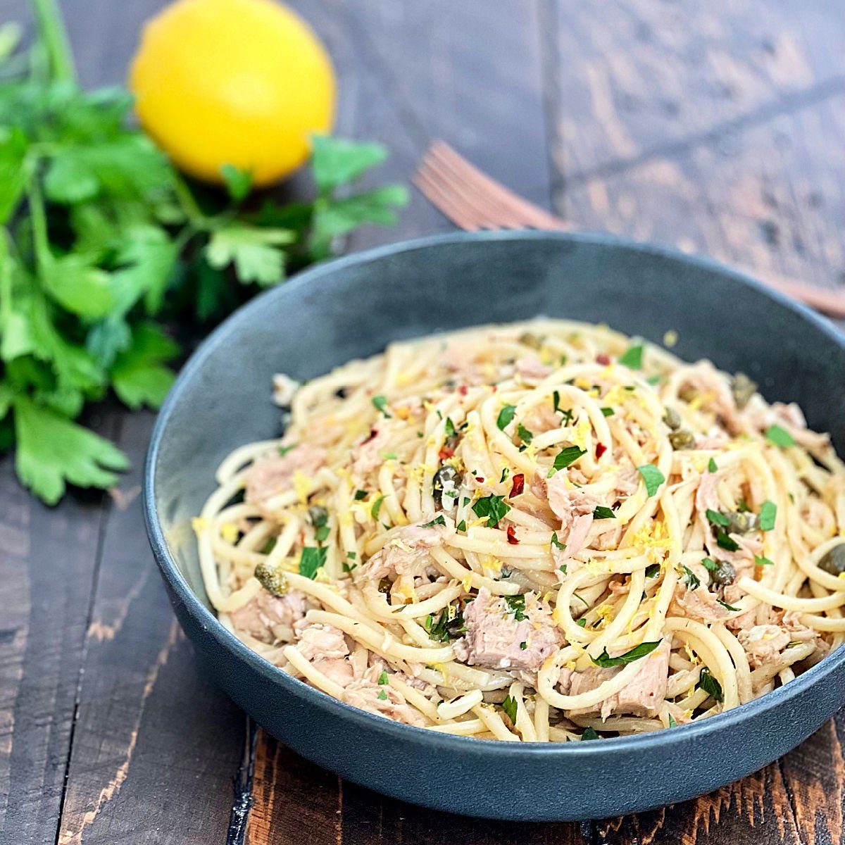 Tuna pasta in a dark gray bowl.