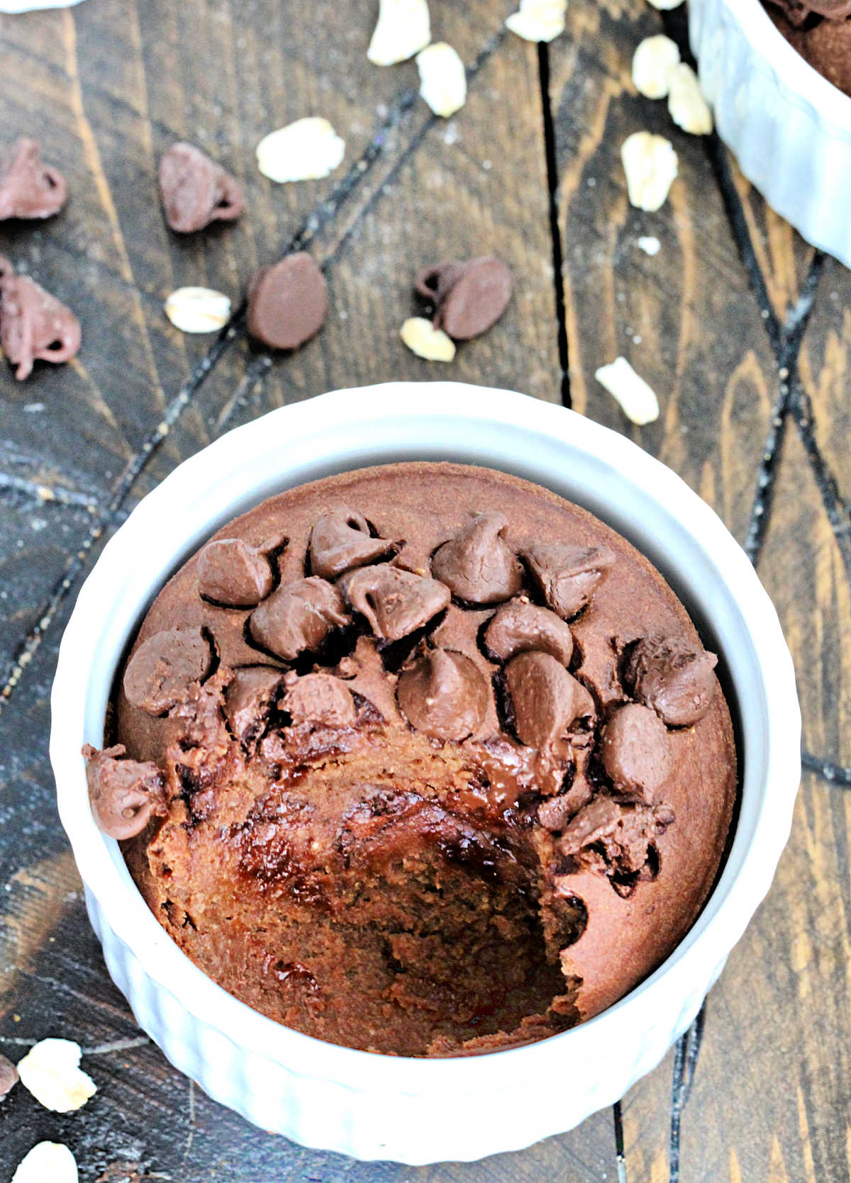 Chocolate Baked Oats in a white ramekin with a scoop taken out