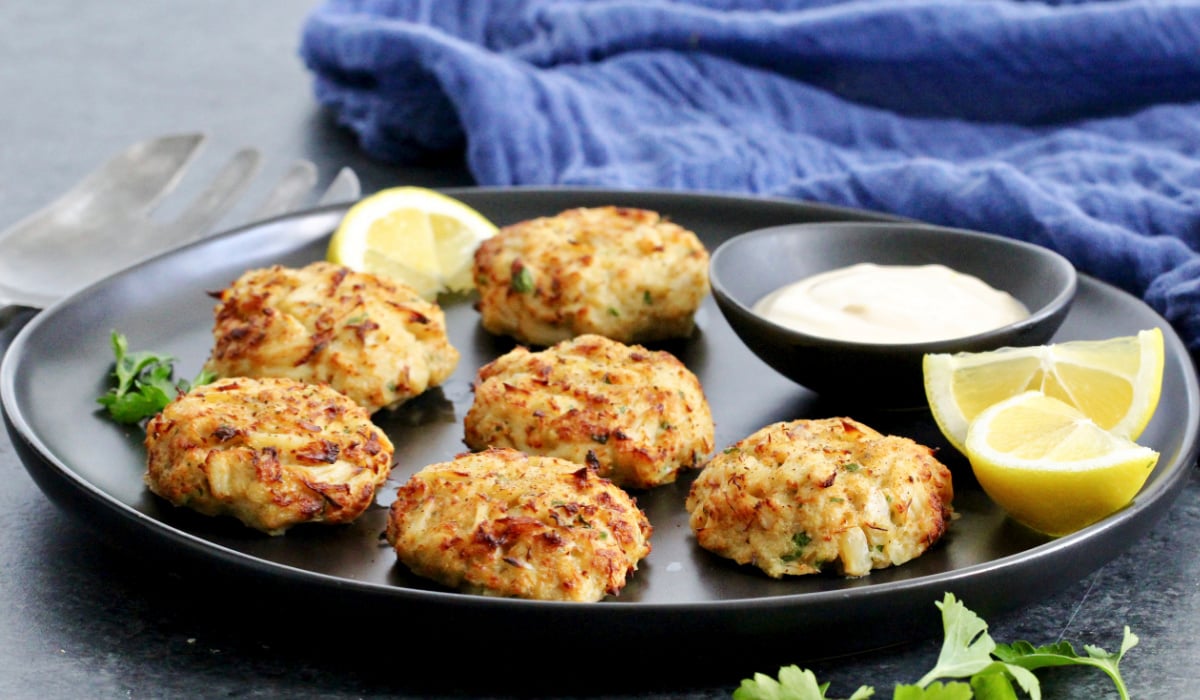 Maryland-style Old Bay crab cakes on a black plate.