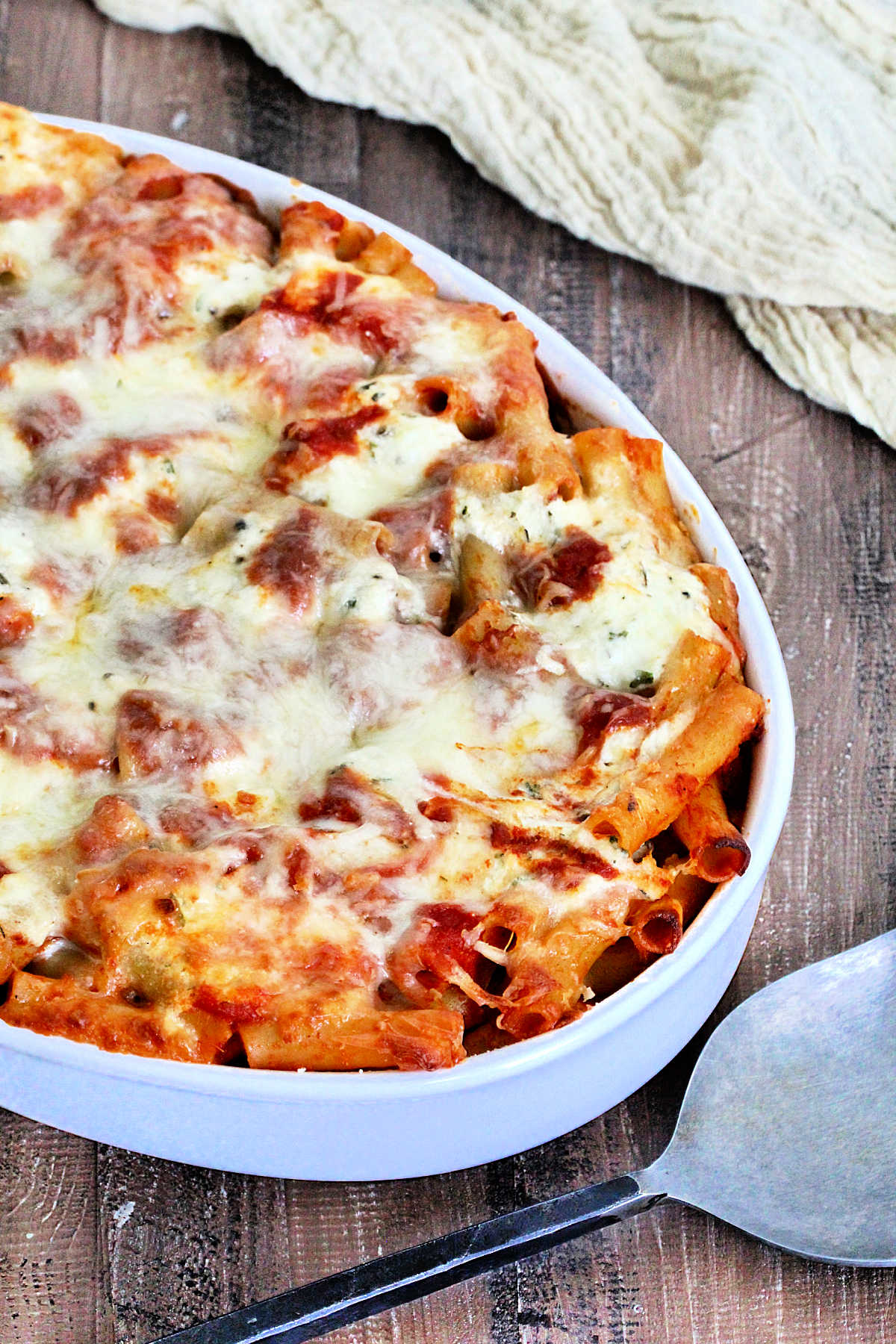 Tray of baked ziti a white serving dish
