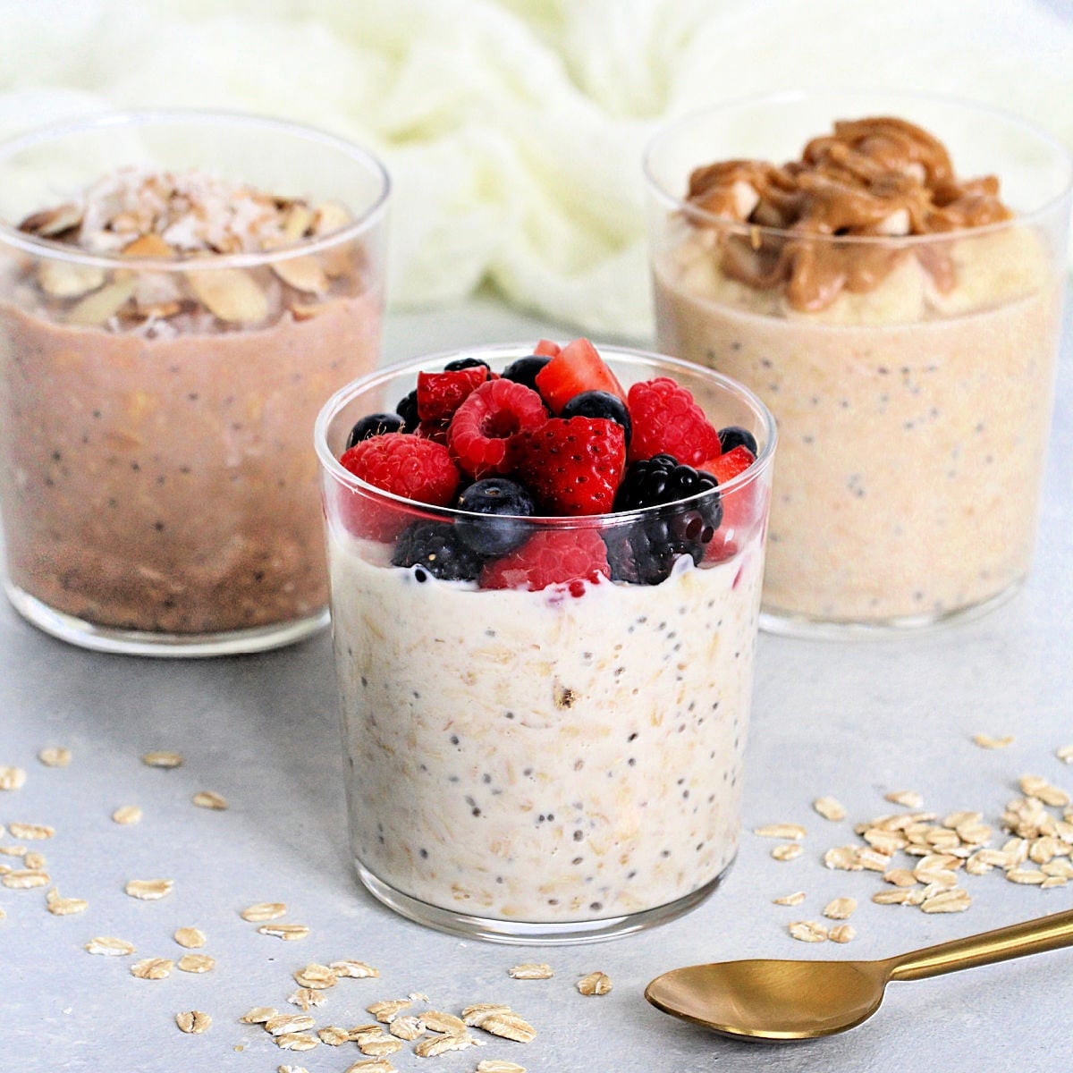3 cups of protein overnight oats with different toppings.