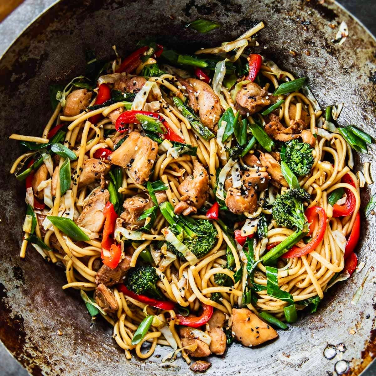 Chicken udon noodles in a wok.