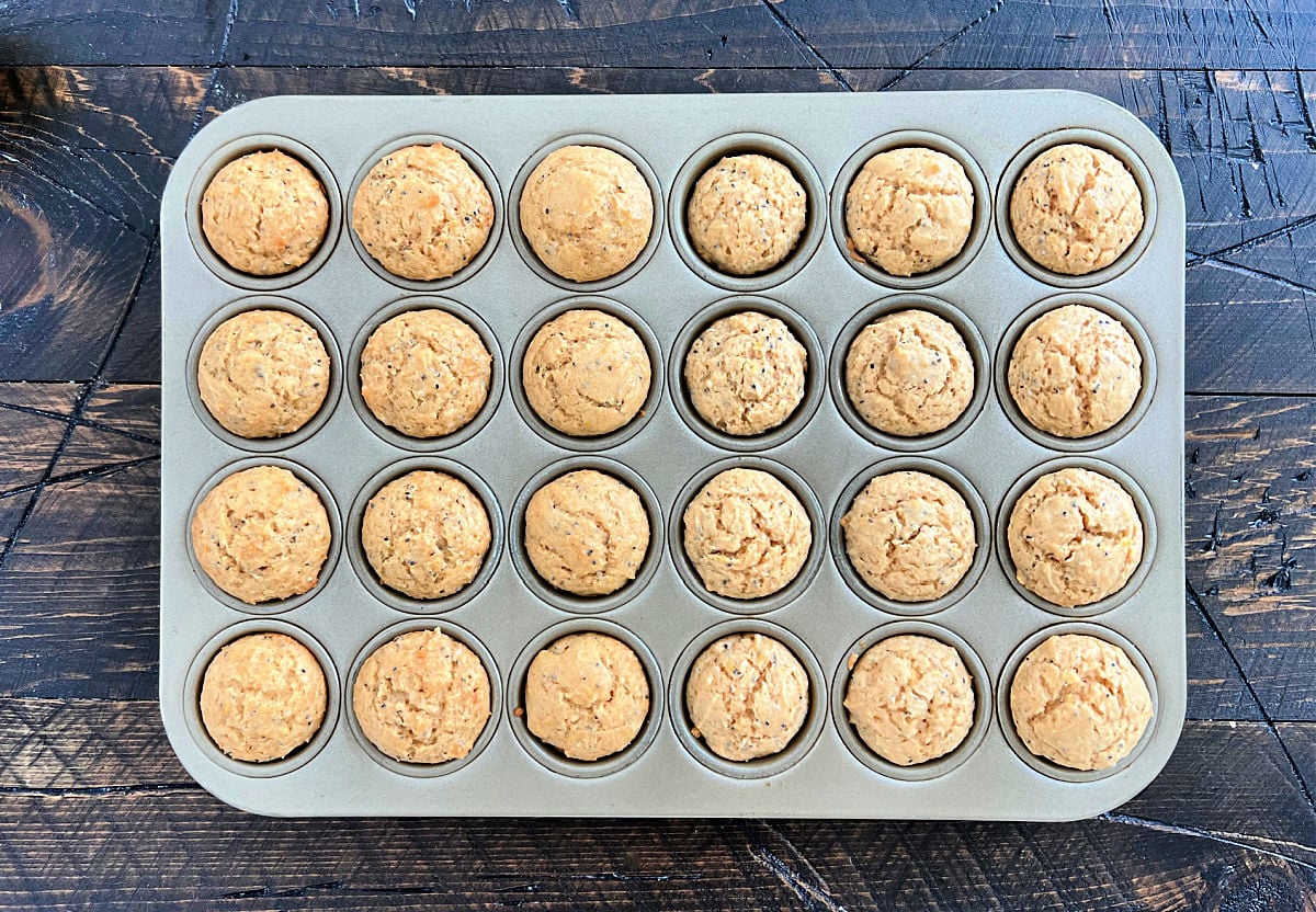 Lemon chia seed muffins in a muffin pan.
